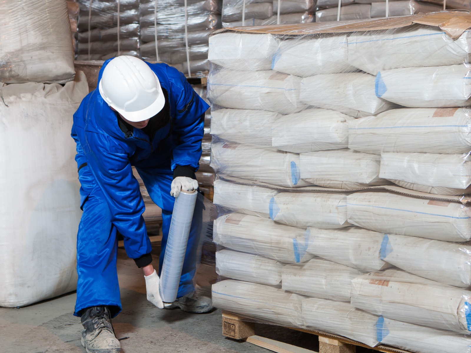 A worker applying stretch wrap to a pallet.